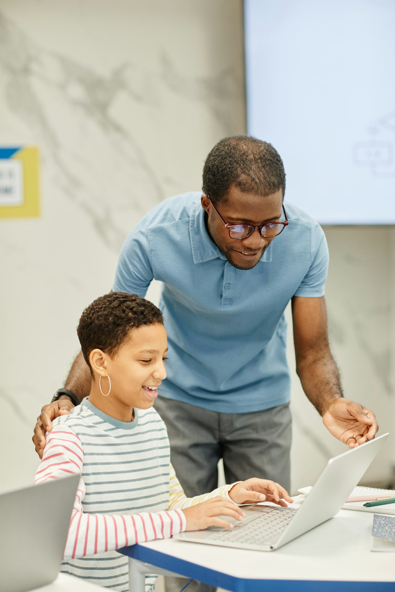 Teacher Helping Student in Class